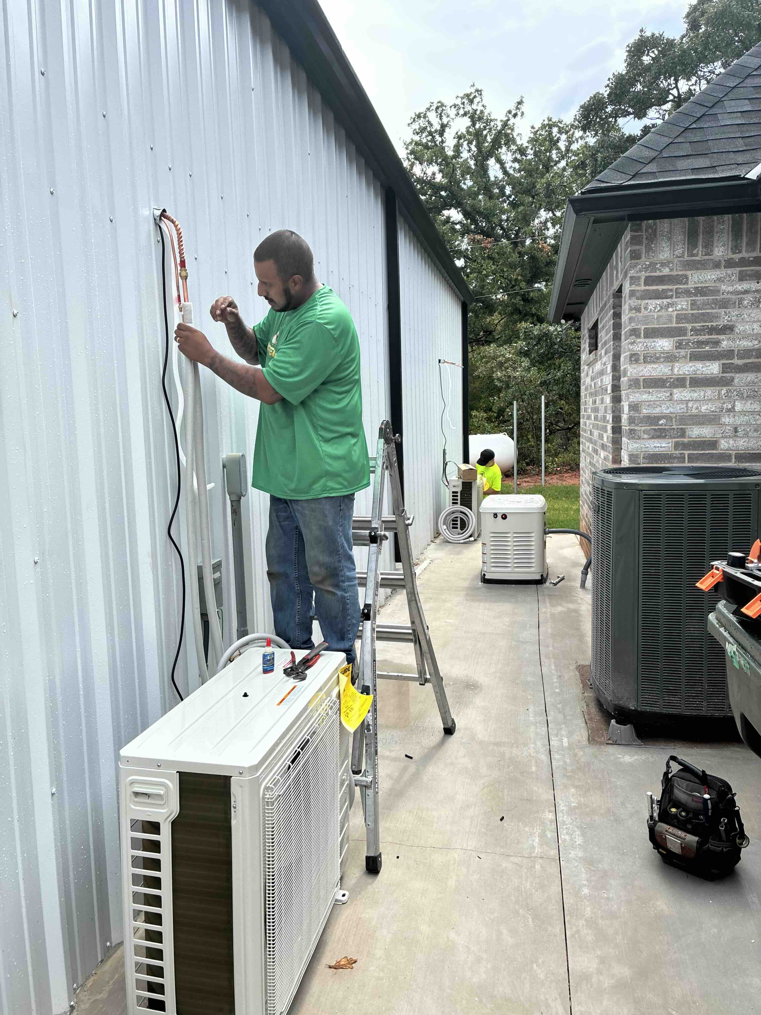 Direct Air technician servicing an outdoor HVAC system